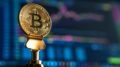 selective focus photo of Bitcoin near monitor